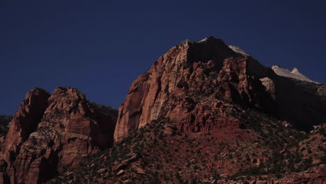 Car-Drives-past-Rocky-Landscape-in-Zion-National-Park