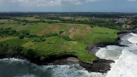 aerial drone footage, coastline with black rocks in bali