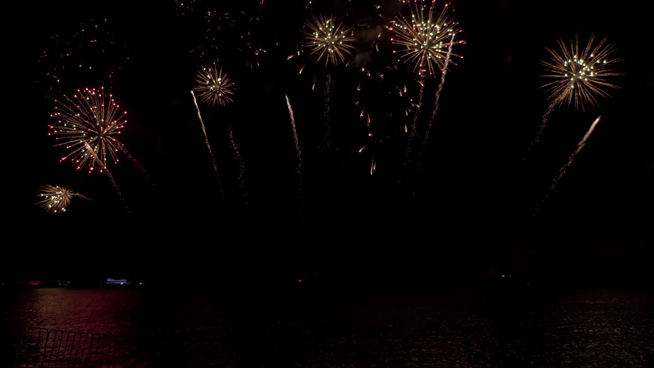 Amazing beautiful colorful firework display over sea on celebration night
