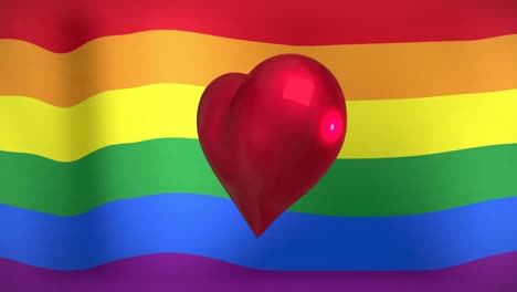 animación del corazón girando sobre la bandera del arco iris