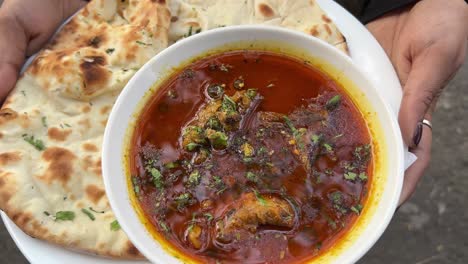 served mutton nihari with large dhaniya khameri roti during daytime.