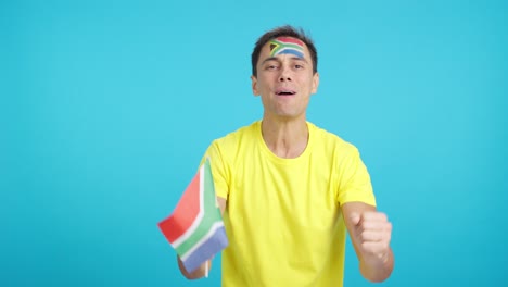 Man cheering for South Africa during a match that is lost