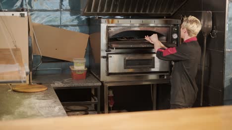 chef preparing pizza toppings in a restaurant kitchen