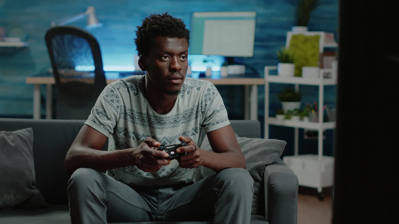 Person playing video games with joystick and TV console