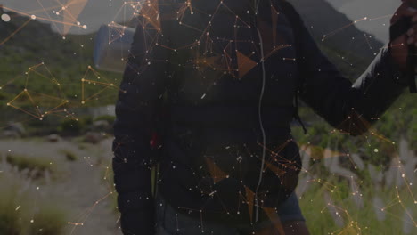 woman hiker gripping pole hiking mountain trail, with orange node network for tech presentation