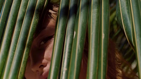 woman in palm leaves