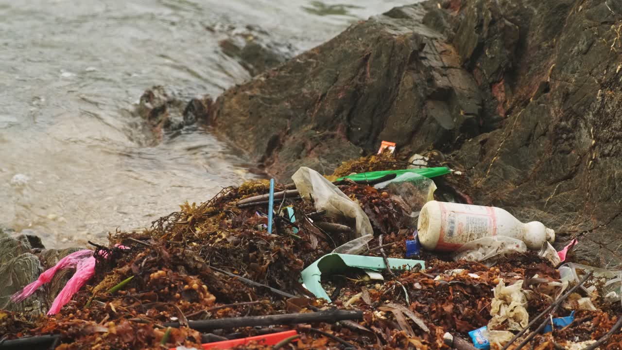 Close up shot of plastic,garbage,trash and waste on beach shore in Asia