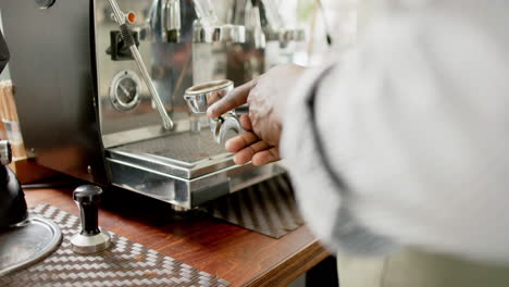 african american barista operates a professional espresso machine