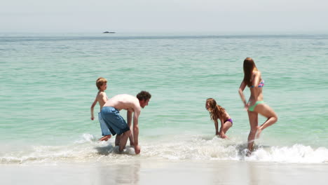 happy family playing in water