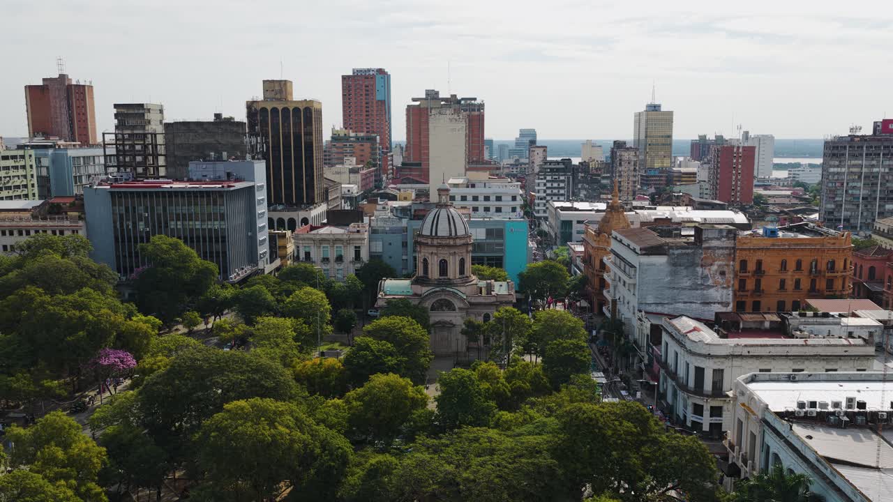 Pantheon of the National Heroes with domed roof surrounded by plazas and colonial buildings near central Asunción, Paraguay. Dolly in aerial