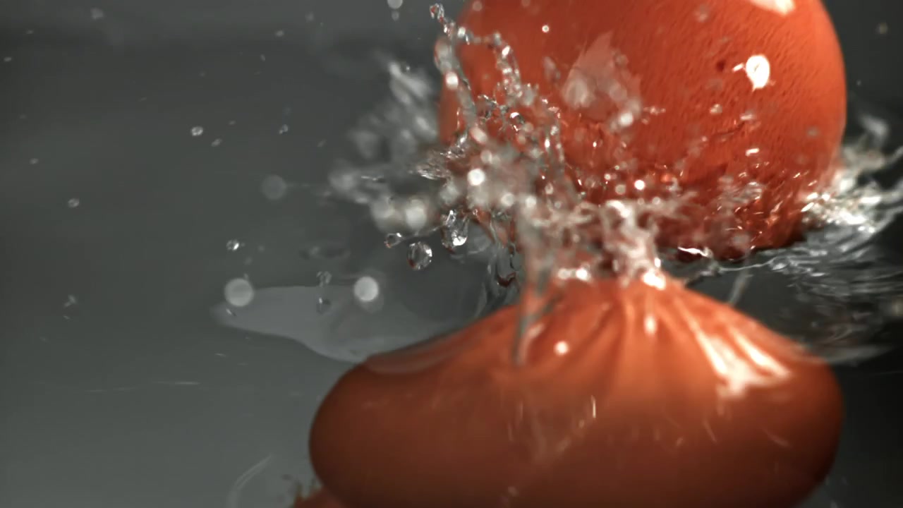 Brown Eggs Falling into Water and Splashing in Slow Motion
