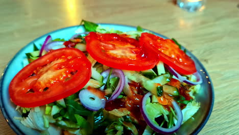 Delicious-fresh-salad-in-bowl,-moving-away-view