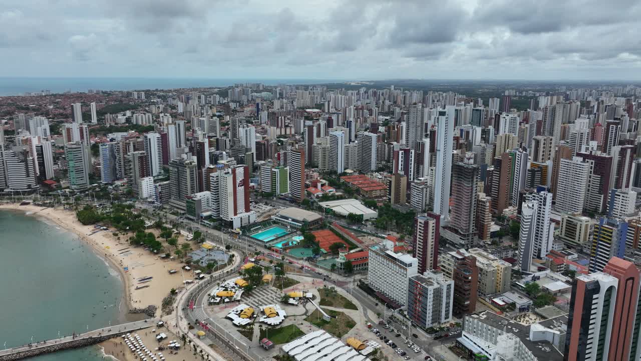 Urban skyline and dense beachfront buildings in Fortaleza, Brazil, aerial establishing ascend
