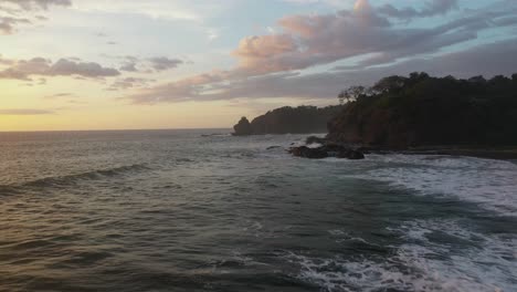 Aerial-shot-of-rocks-and-waves-along-coast