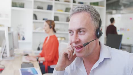 man talking to a customer with headphone