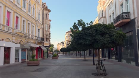the main pedestrian street on a summer morning with few people. the center of plovdiv. many houses along main street today are cultural monuments, built at the beginning of the 20th century.