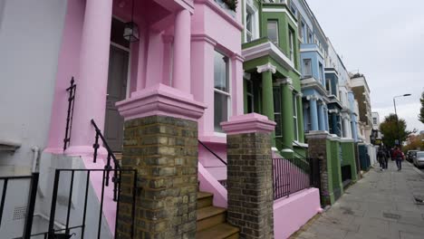 street view of the colorful houses with balconies located in notting hill, london.