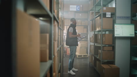 warehouse worker checking inventory with tablet