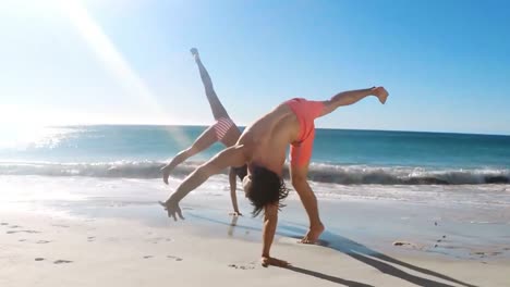 Paar-Macht-Salto-Am-Strand