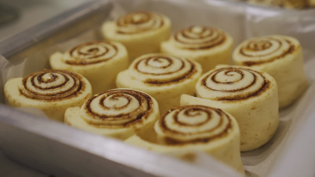 Baking Tray With Parchment Paper Full Of Cinnamon Rolls
