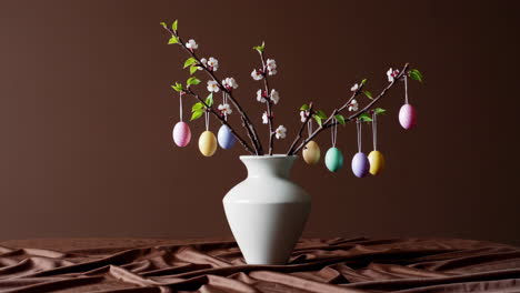 easter decoration with colorful eggs and cherry blossom branches in a vase