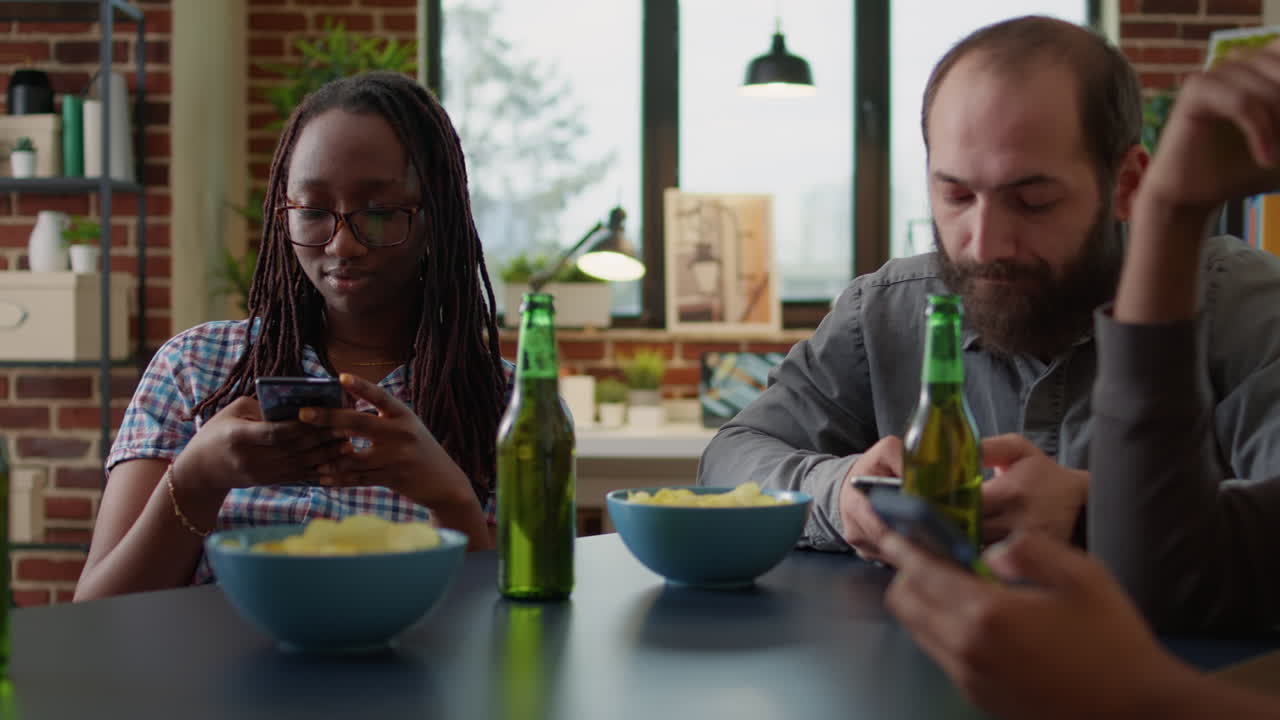 Multiethnic group of friends meeting at home to use smartphones