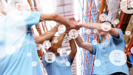 Animation-of-network-of-connections-smiling-people-stacking-hands-over-warehouse