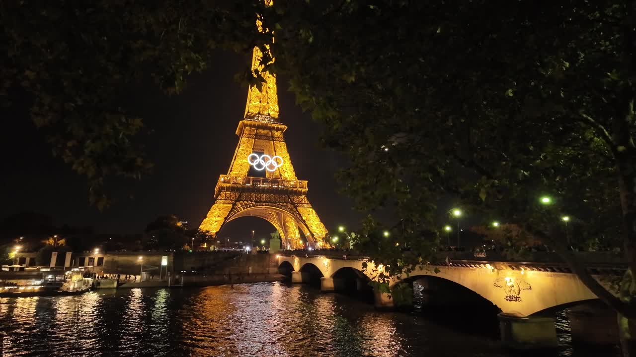Eiffel tower Olympic rings at night Paris France light up, tourist landmark