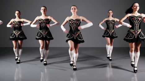 group of five women performing irish dance in studio