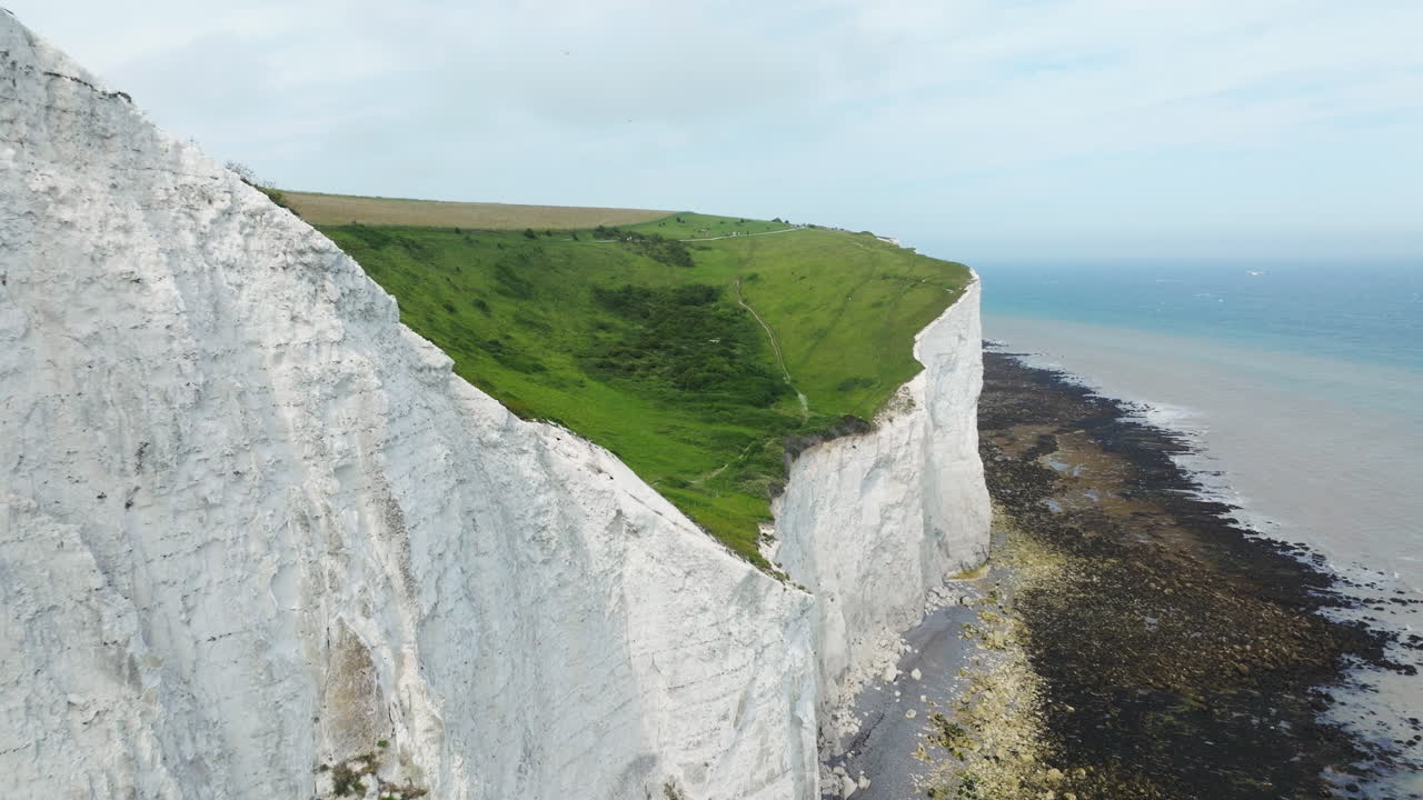 Detail View Of White Cliffs Of Dover With Grassy Hills In Kent, England, UK. - aerial shot
