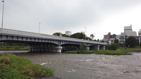 bridge crossing above kamo river, urban park in kyoto japan at summer daylight