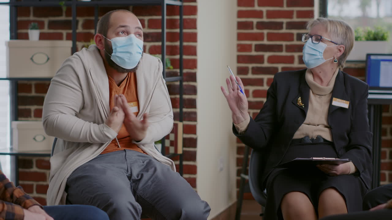 Man with anger manangement issues talking to psychiatrist at aa therapy session