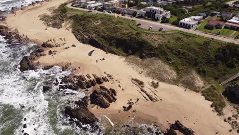 Paraglider-flying-from-beachside-cliffs-at-paragliding-site-in-La-Pedrera-village-on-Atlantic-Coast,-Uruguay