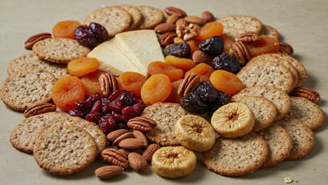 a vibrant arrangement of savory crackers, dried fruits, and nutty delights creating a colorful and tantalizing snack spread for any occasion