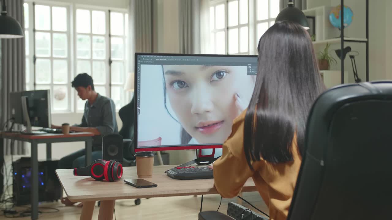 Back View Of Asian Female Digital Editor Celebrating While Works In Photo Editing Software On Her Personal Computer With Big Display In Office