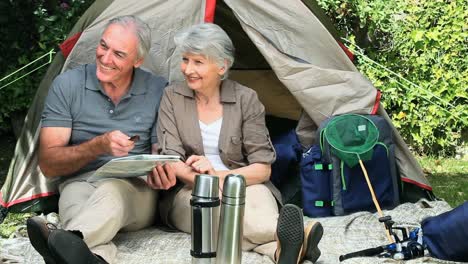 seniors sitting near a tent