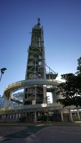 industrial chimney of former galp refinery with spiral walkway surrounded by buildings in parque das nacoes lisbon