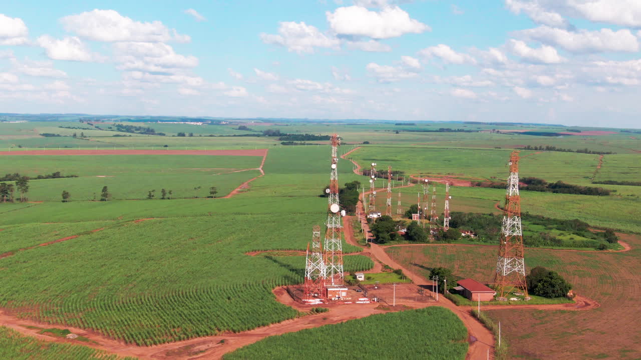 Drone aerial landscape of communication towers antenna network system structures in rural farmland countryside Brazil infrastructure broadcast technology internet satellite