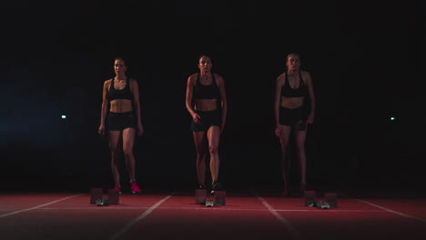 three girls athletes at the start preparing for the race and start on the treadmill.