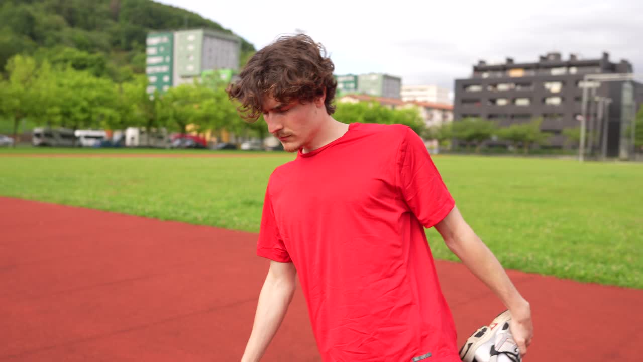 Man Stretching on Track and Field