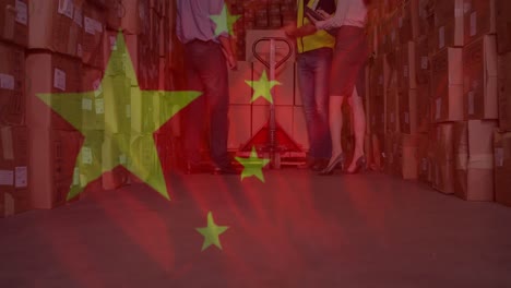 Animation-of-chinese-flag-flowing-over-people-working-in-warehouse