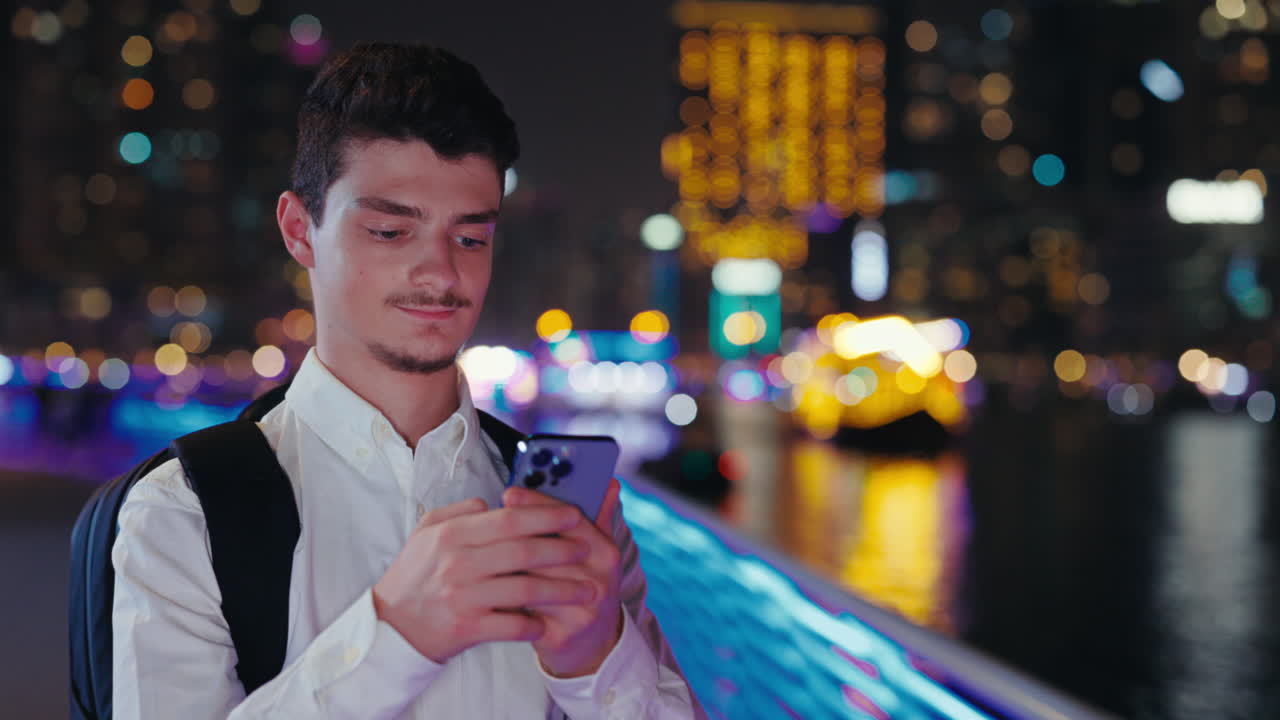 Man using mobile phone in the city at night