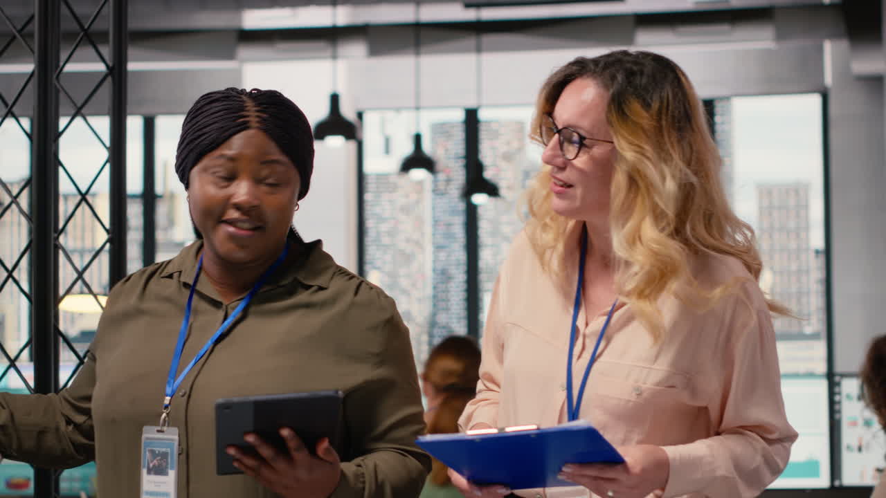 Vertical Video Diverse women professionals focus on report writing and analytics