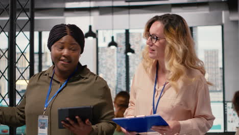vertical video diverse women professionals focus on report writing and analytics