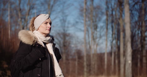 smiling female tourist walking trail in mountains