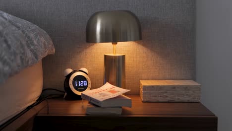 Modern-bedside-table-details-with-clock-and-books-and-a-small-warm-lamp-light