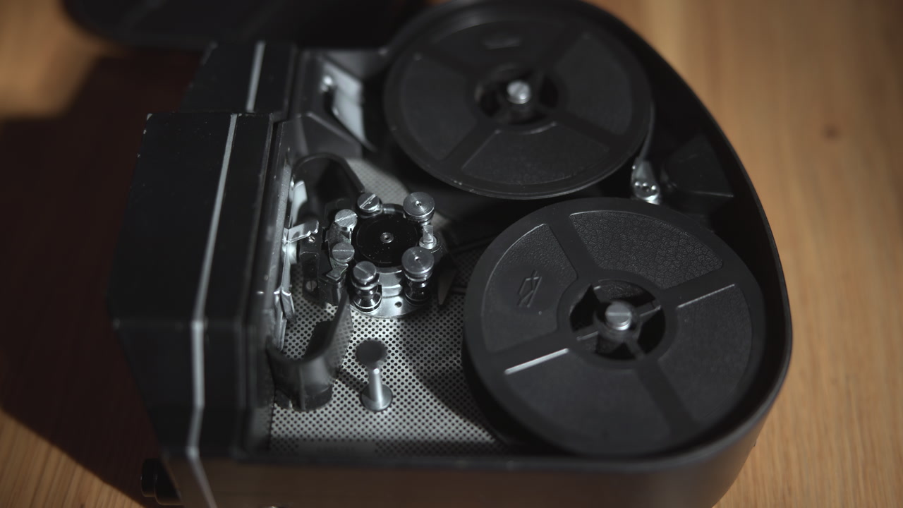 Open Projector Interior With Dual Reels And Sprocket, Hand Adjusting Mechanism On Wooden Tabletop, Workshop . Media