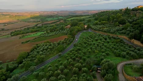 Aerial-at-sunset-over-the-Tuscany-landscape-near-Pienza,-Province-of-Siena,-Italy