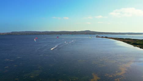 Toma-Panorámica-De-Drones-De-La-Competencia-De-Kitesurf-En-Punta-Tretto,-San-Giovanni-Suergiu,-Sur-De-Cerdeña,-Italia