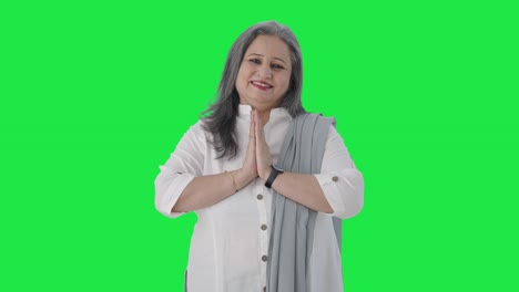 Happy-Indian-senior-businesswoman-greeting-and-doing-Namaste-Green-screen